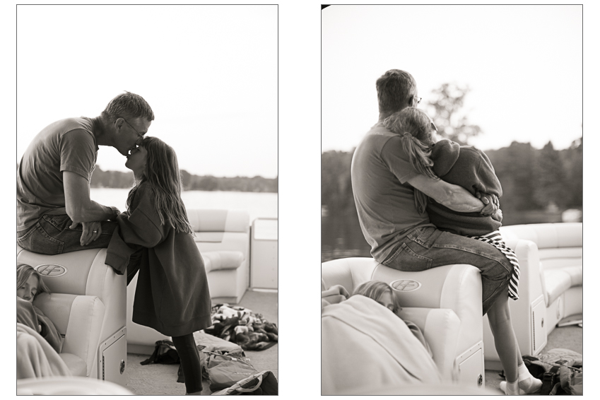 A father and daughter snuggle on a boat